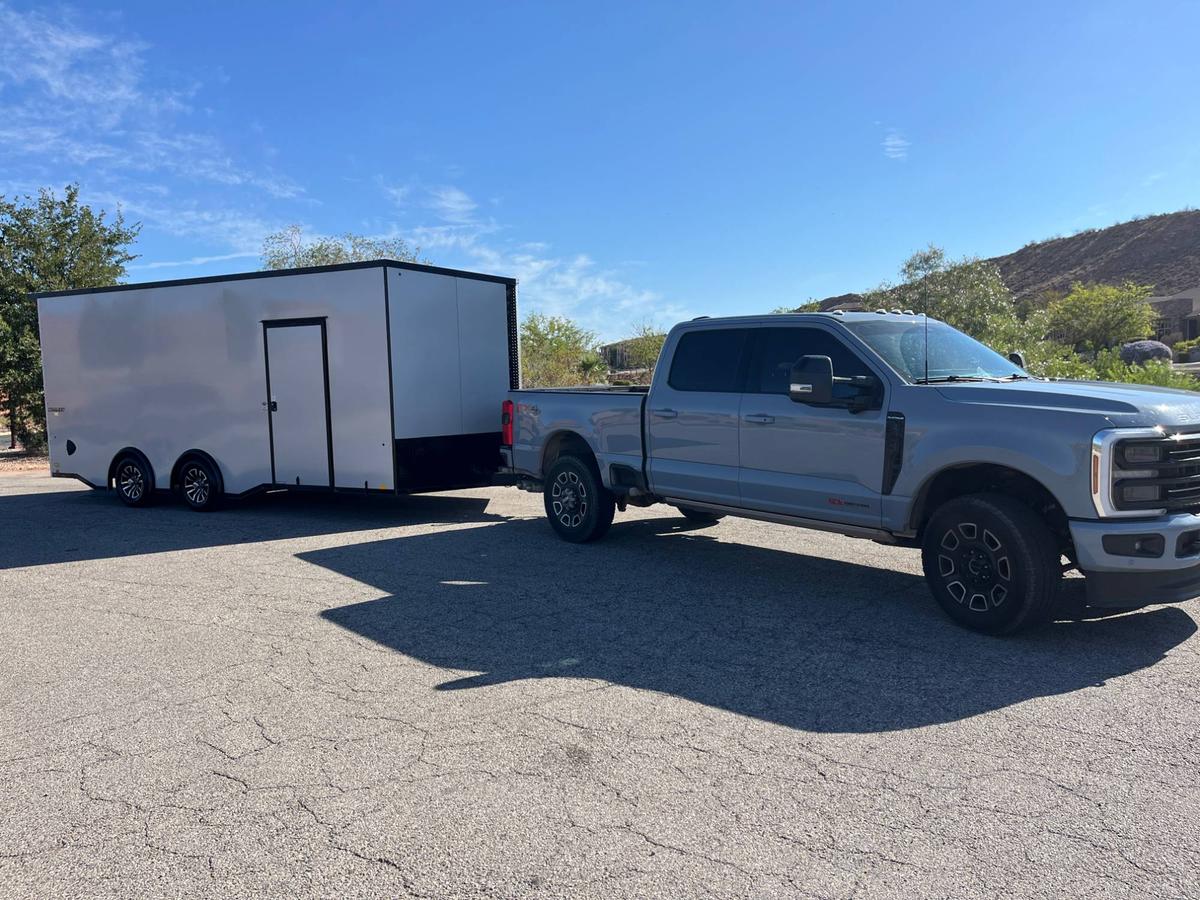 Apple Pie Transport's gray Super Duty diesel and fully enclosed white trailer